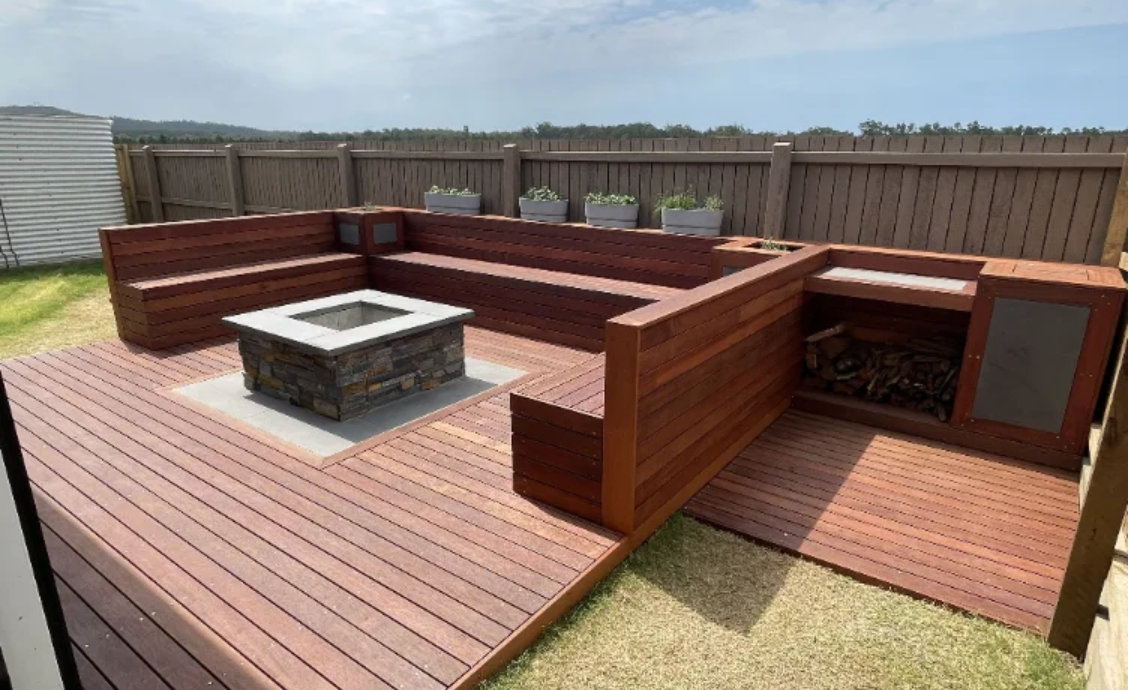 Timber deck with built-in bench seating and fire pit